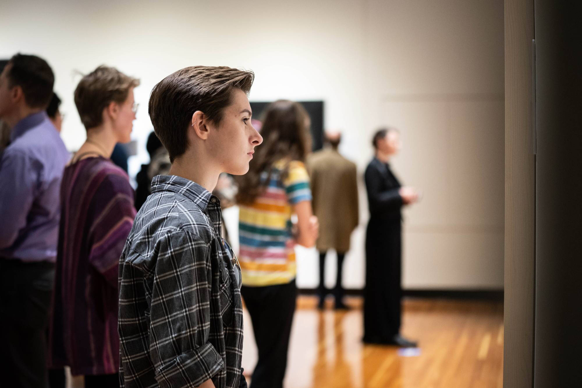 student looking at art in a gallery